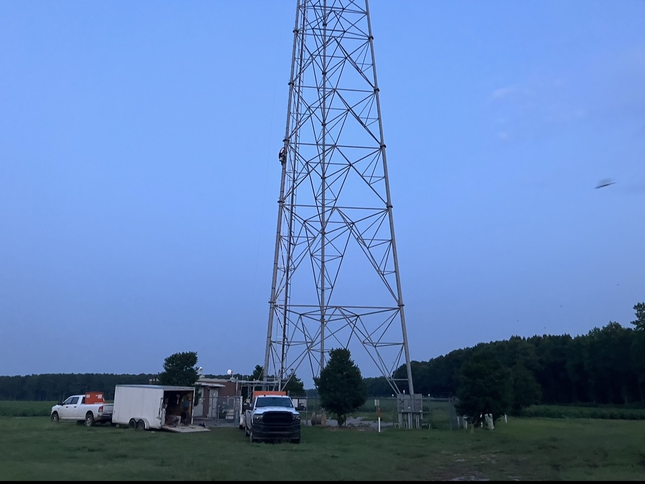 Tower with maintenance trucks at its base